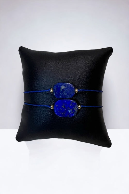 At the core of this bracelet lies a rectangular Lapis Lazuli gemstone, celebrated for its rich, celestial blue color and flecks of golden pyrite. Paired with gold hematite beads, this bracelet is a symbol of wisdom and truth, encased in elegance.